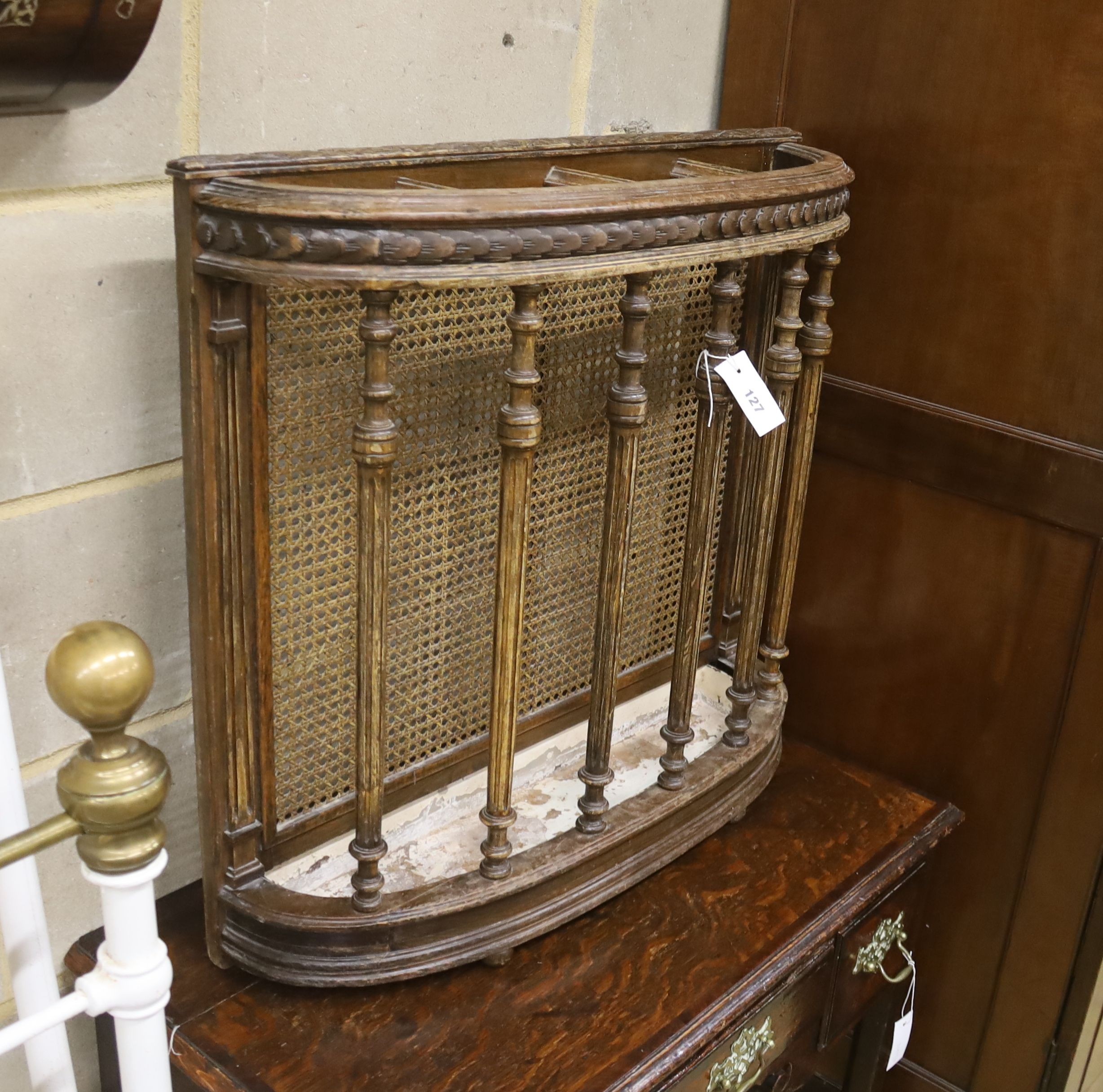 An early 20th century caned beech four division stick stand, width 73cm, depth 20cm, height 68cm